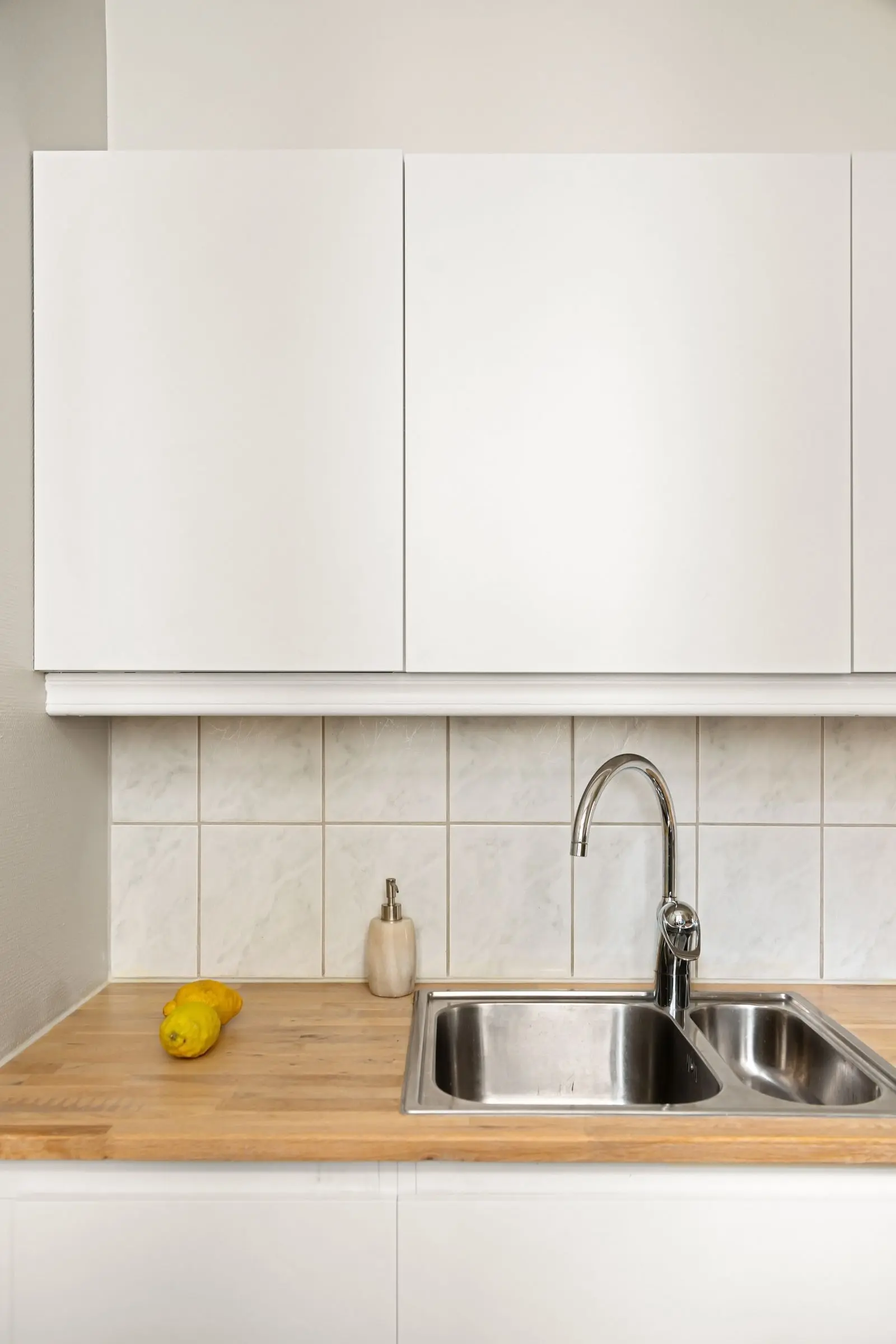 Stainless steel double kitchen sink with a chrome faucet